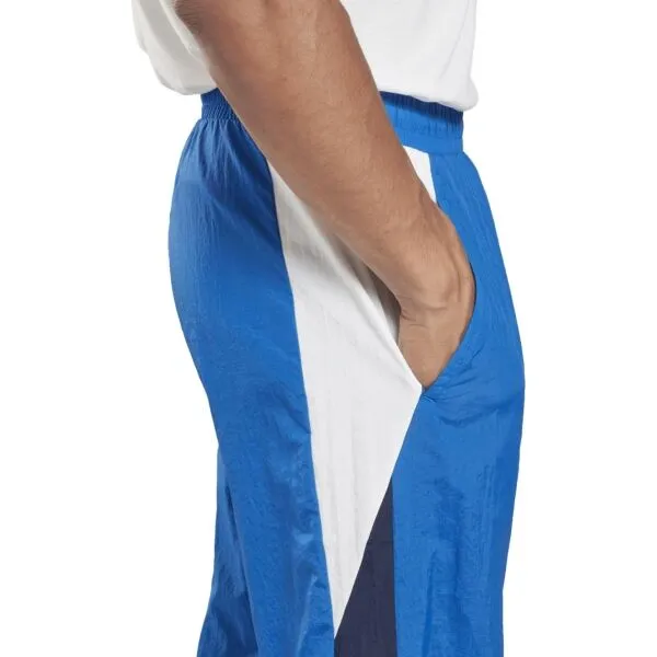 Reebok TRAIN WOVEN PANT Pánske šuštiakové nohavice, modrá, veľkosť