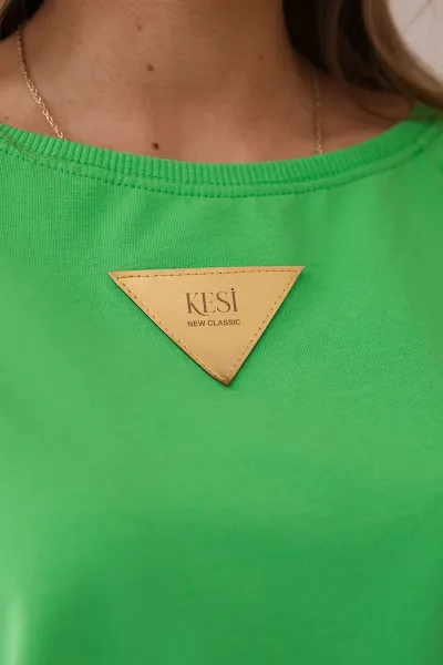 Cotton blouse with ruffles on the shoulders in light green color