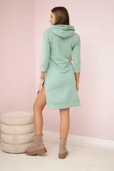 Dress with a longer back and a colorful dark mint print