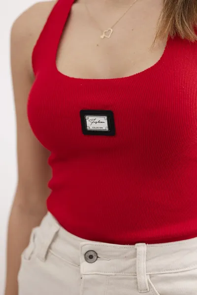 Striped blouse with red metal plate