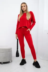 Complete with an oversized blouse in red