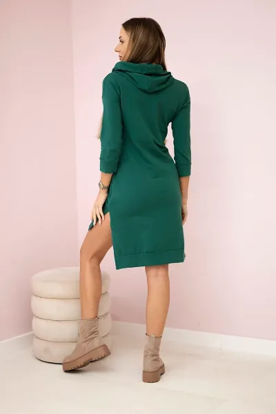 Dress with a longer back and a colorful print in dark green