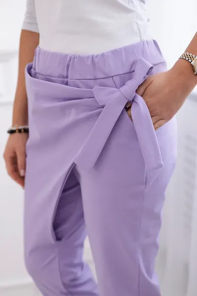 Trousers tied with an asymmetrical light purple front
