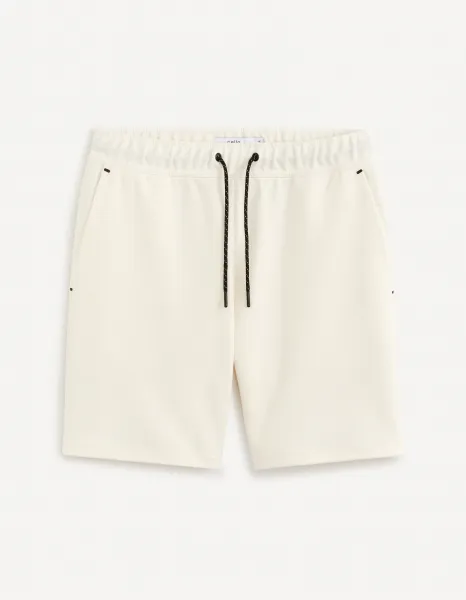 Krémové pánske teplákové kraťasy Celio Donewshort